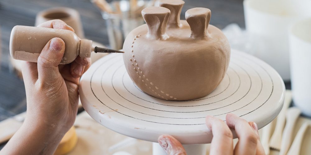 child-in-the-process-of-decorating-the-clay-vase-resize