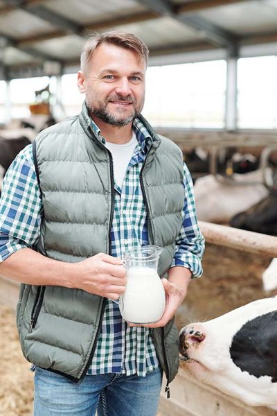 happy-young-worker-of-dairy-farm-holding-jug-with-resize