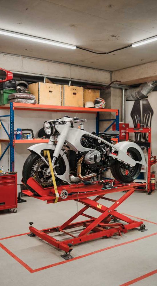 Fixing Custom motorcycle standing in repair shop. Instruments and equipment. Hobbies and unique Jobs