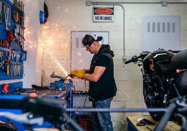 motorcycle-mechanic-using-a-grinder-B3JSF5V-resize