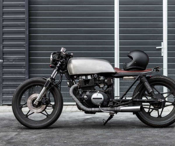 Custom motorcycle parking near industrial building. Everything is ready for having fun driving the empty road on a motorcycle tour journey. Hipster city hobby. Space for your individual text.