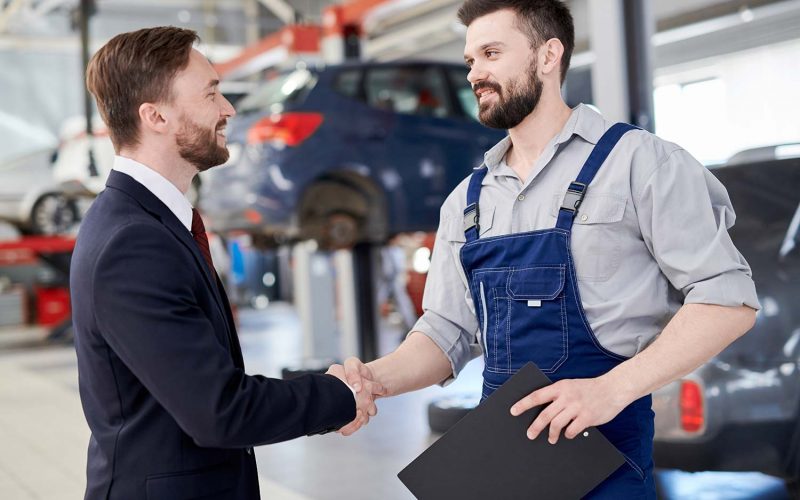 mechanic-shaking-hands-with-businessman-small