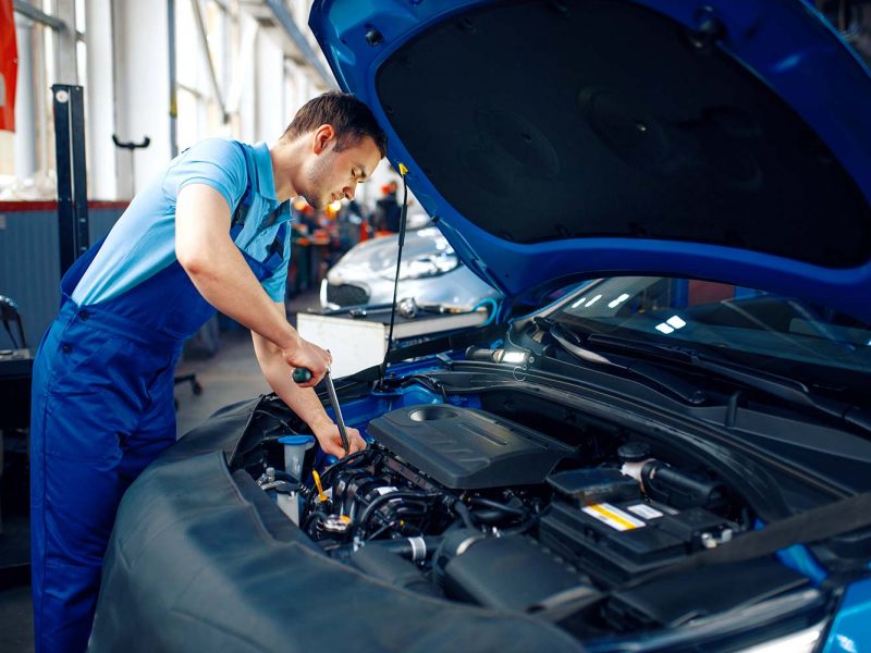 worker-in-uniform-checks-engine-car-service-small